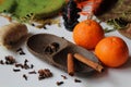 Winter time - two tangerines and spice - ginger, cloves, star aniseed, black pepper and cinnamon arranged on a wooden bowl Royalty Free Stock Photo