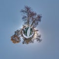 Winter tiny planet in snow covered forest on wooden bridge. transformation of spherical panorama 360 degrees. Spherical abstract Royalty Free Stock Photo