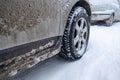 Winter tire. Car on snow road. Tires on snowy highway detail Royalty Free Stock Photo