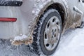Winter tire. Car on snow road. Tires on snowy highway detail Royalty Free Stock Photo