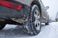 Winter tire. Car on snow road. Tires on snowy highway detail Royalty Free Stock Photo