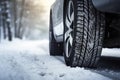 Winter tire. Detail of car tires in winter on the road covered with snow.