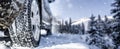 Winter tire. Detail of car tires in winter on the road covered with snow. Panorama, banner. Royalty Free Stock Photo
