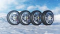 Winter tires on a background of snowstorm, snowfall and slippery winter road. Winter tires concept. Concept tyres Royalty Free Stock Photo