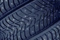Winter tires for the car. Radial tread, thin lamellas and metal spikes Royalty Free Stock Photo