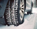 Winter tires on a frosty and snowy road. Winter driving safety concept