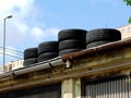 winter tires stored on top of decaying garage roof