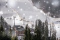 Winter tourism in Eastern Europe. Modern ski lift on a background of blue sky. Ski resort `Bukovel`, Ukraine. Winter snowfall