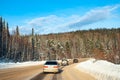 Winter track in the Siberian taiga on a sunny frosty day