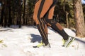 Winter trail running: man takes a run on a snowy mountain path in a pine woods. Royalty Free Stock Photo