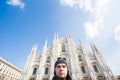 Winter travel, vacations and holidas concept - Young funny man taking selfie near Milan Cathedral Duomo di Milano, Italy