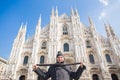 Winter travel, vacations and holidas concept - Young funny man taking selfie near Milan Cathedral Duomo di Milano, Italy