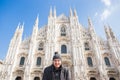 Winter travel, vacations and holidas concept - Young funny man taking selfie near Milan Cathedral Duomo di Milano, Italy