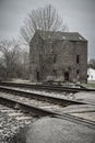 Winter trees, old warehouse and railroad tracks Royalty Free Stock Photo