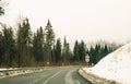 Winter trip by car. A sharp turn and warning road signs on the road in the mountains Royalty Free Stock Photo