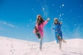 Winter, two girls having fun in the snow in the mountains Royalty Free Stock Photo