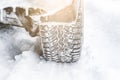 Winter tyre. Car tires on winter road covered with snow Royalty Free Stock Photo