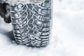 Winter tyre. Car tires on winter road covered with snow Royalty Free Stock Photo