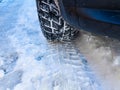 Winter tyre with tracks close up shot on the snow Royalty Free Stock Photo