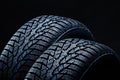 Winter tyres on black background with contrasty lighting Royalty Free Stock Photo