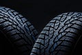 Winter tyres on black background with contrasty lighting Royalty Free Stock Photo