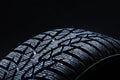 Winter tyres on black background with contrasty lighting Royalty Free Stock Photo