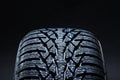 Winter tyres on black background with contrasty lighting Royalty Free Stock Photo