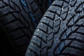 Winter tyres on black background with contrasty lighting Royalty Free Stock Photo