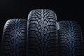 Winter tyres on black background with contrasty lighting Royalty Free Stock Photo