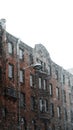 Winter urban city house in snowstorm with huge snowflakes falling during the blizzard and whiteout covering the city. Royalty Free Stock Photo