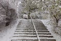 Winter urban landscape. Trees, paths and stairs under snow Royalty Free Stock Photo
