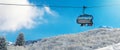 winter vacation - chair lift above snowy mountain landscape