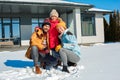 Winter vacation. Family time together outdoors standing near house hugging smiling cheerful Royalty Free Stock Photo