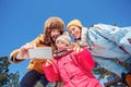 Winter vacation. Family time together outdoors taking selfie on smartphone grimacing to camera playful bottom view Royalty Free Stock Photo