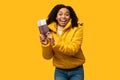 Black Girl Showing Tickets Going On Winter Vacation, Yellow Background Royalty Free Stock Photo