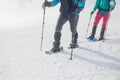 winter vacation. snowshoes for walking in the snow. two girls with backpacks walk along a mountain path on snowshoes. walk in the Royalty Free Stock Photo