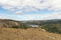 Winter VegetationHhills Valleys and Dam Against Cloudy Sky Royalty Free Stock Photo