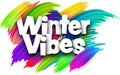 Winter vibes paper word sign with colorful spectrum paint brush strokes over white