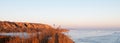 Winter view of clay mountains, and hills near the Dnieper estuary. The water is covered with ice. Stanislav, Ukraine.