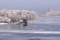 Winter view of the Dnieper river, the barge moored, trees in hoarfrost, buildings of city. Hydro-park, Kiev, Ukraine Royalty Free Stock Photo