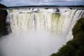 Winter view of Iguazu Falls Devil`s Throat under heavy clouds lead sky. Border of Brazil and Argentina. National Park.