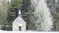 Winter view little snow-capped rural wooden church in frozen for