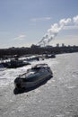 Winter view of the Moscow river embankment and cruise yacht sailing on iced water