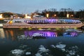 Winter view of the Moscow river embankment and cruise yacht sailing on iced water