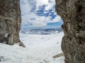 Winter views of the fascinating mountain range from the entrance of a cave in the peak mountains Royalty Free Stock Photo