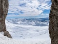 Winter views of the fascinating mountain range from the entrance of a cave in the peak mountains Royalty Free Stock Photo