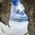 Winter views of the fascinating mountain range from the entrance of a cave in the peak mountains Royalty Free Stock Photo