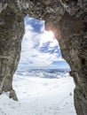 Winter views of the fascinating mountain range from the entrance of a cave in the peak mountains Royalty Free Stock Photo