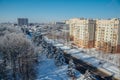 Winter Voronezh cityscape. Frozen trees in a forest covered by snow and hoarfrost near modern houses in the city of Voronezh Royalty Free Stock Photo
