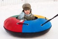 Winter walk, boy rides a Snow-tubing